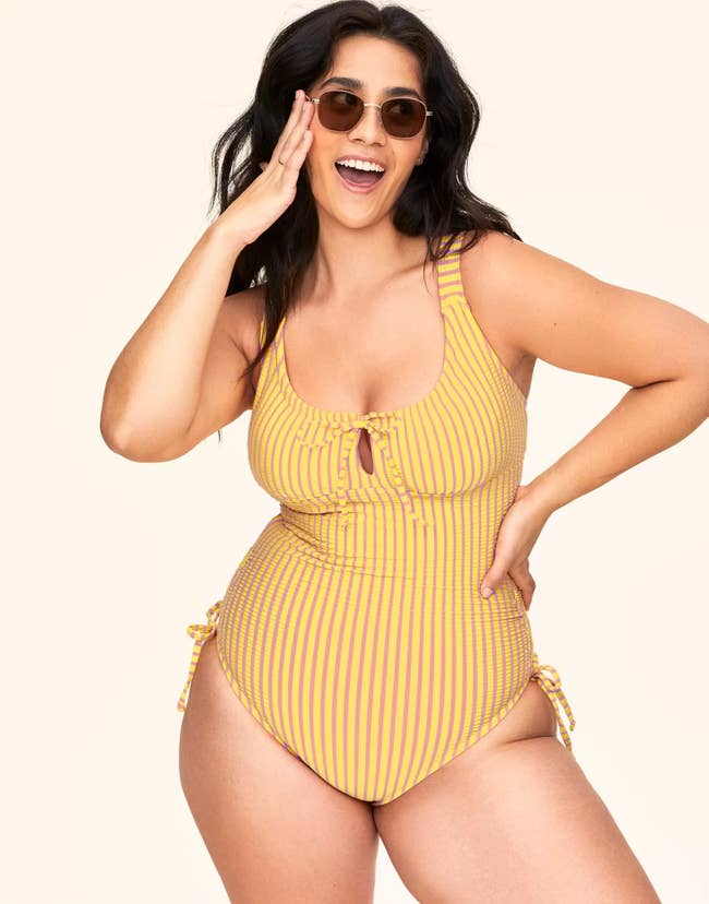 model in striped swimsuit with ties 