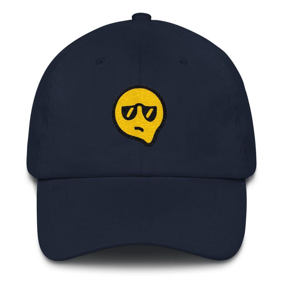 navy cap with melting yellow face wearing sunglasses and a displeased expression