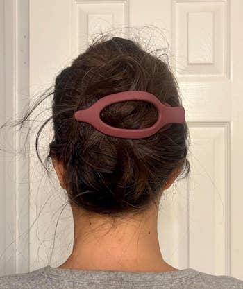 Hair styled successful a escaped bun secured with an oval-shaped hairsbreadth clip