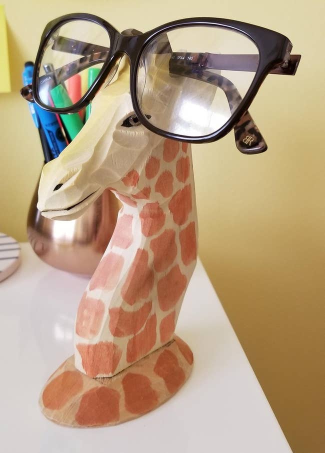 a reviewer's giraffe statue with the glasses propped on top