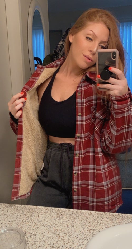 reviewer mirror selfie wearing red plaid shacket, showing fleece lining