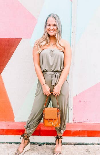 reviewer wearing the olive jumpsuit