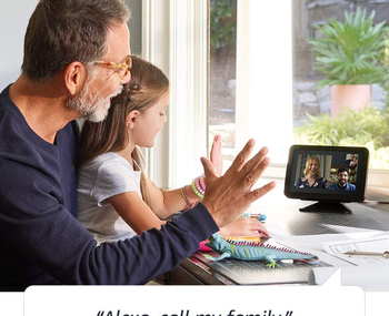 lifestyle image of grandpa and granddaughter video calling family members