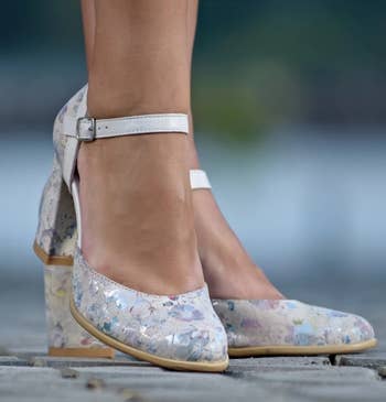 front of model's feet in the floral mary janes