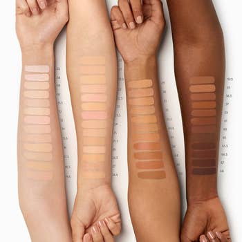 swatches of foundation on four models arms