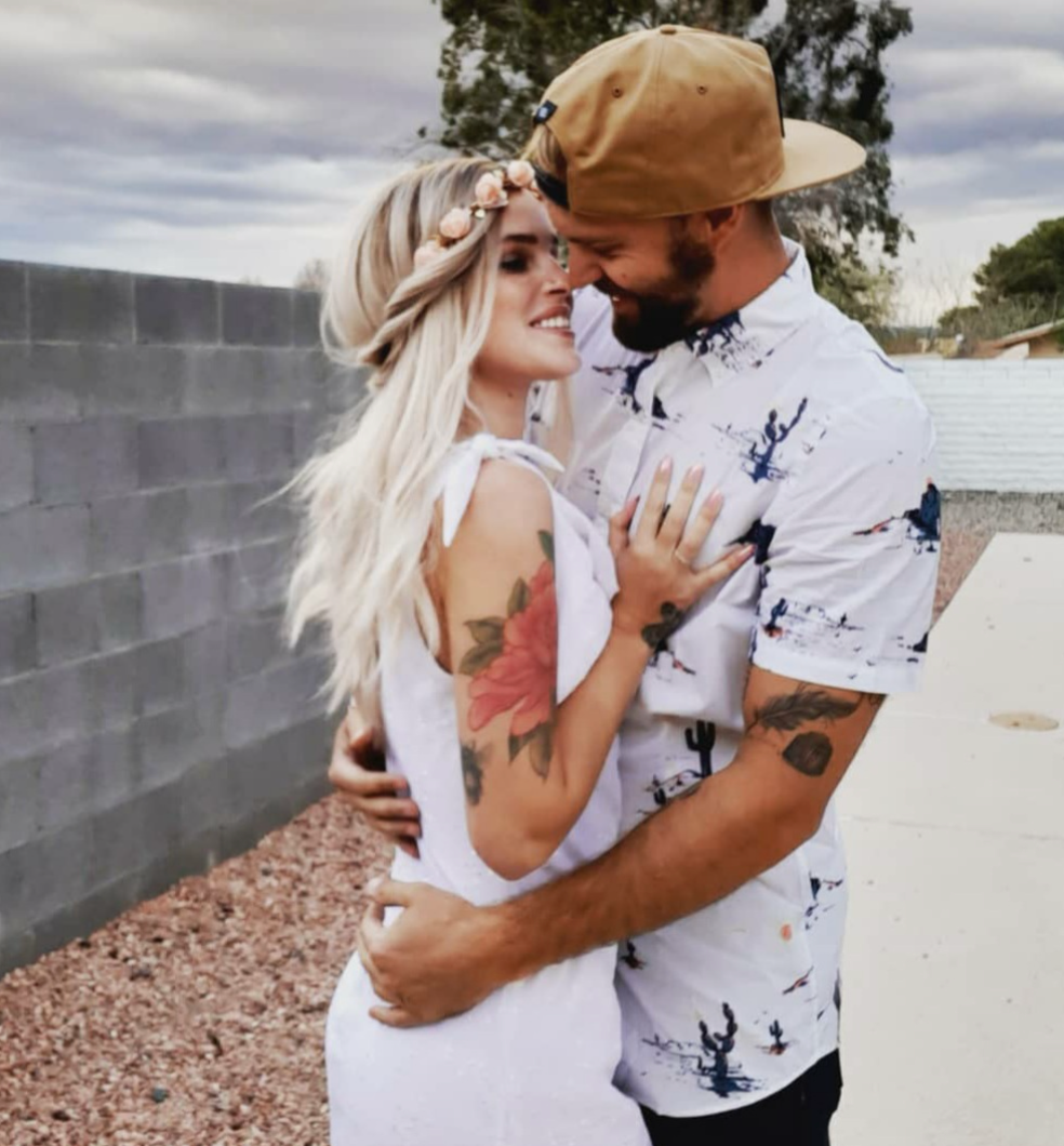 Reviewer photo of two people hugging and one is wearing a short sleeve button down top in a white color with a cactus print throughout