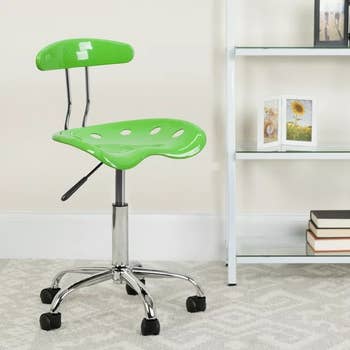 a plastic armless desk chair in bright green 