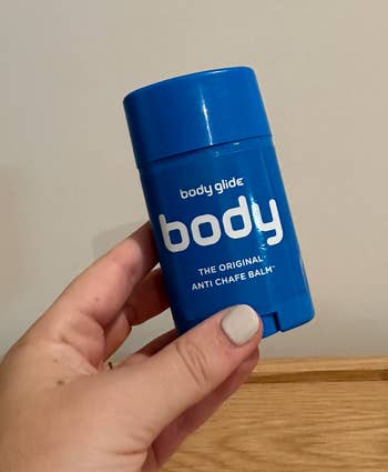 BuzzFeed writer holding the small blue container