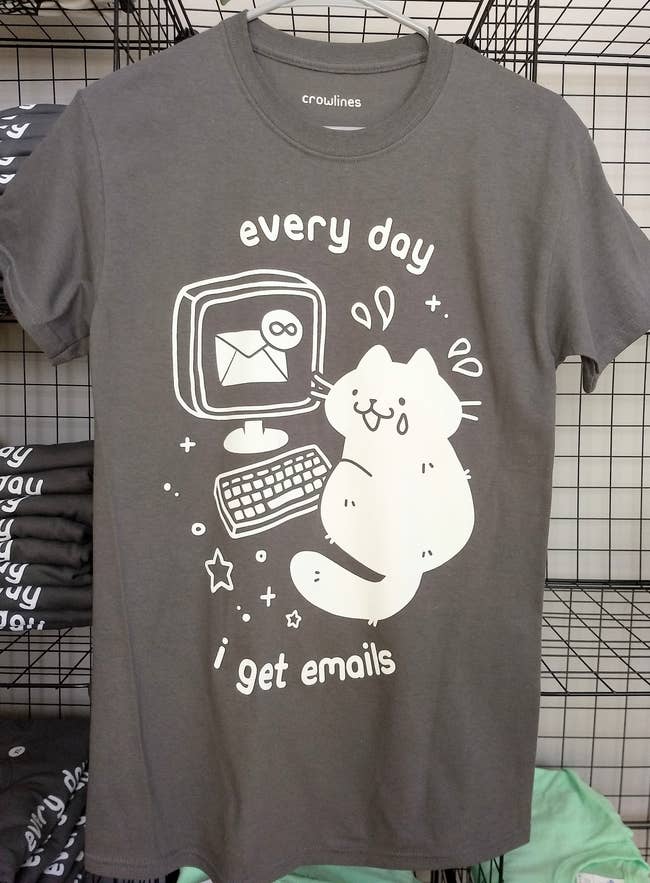 gray short sleeve tee with a white graphic of a cat with a tear on its face in front of a laptop showing inbox infinity and the text 