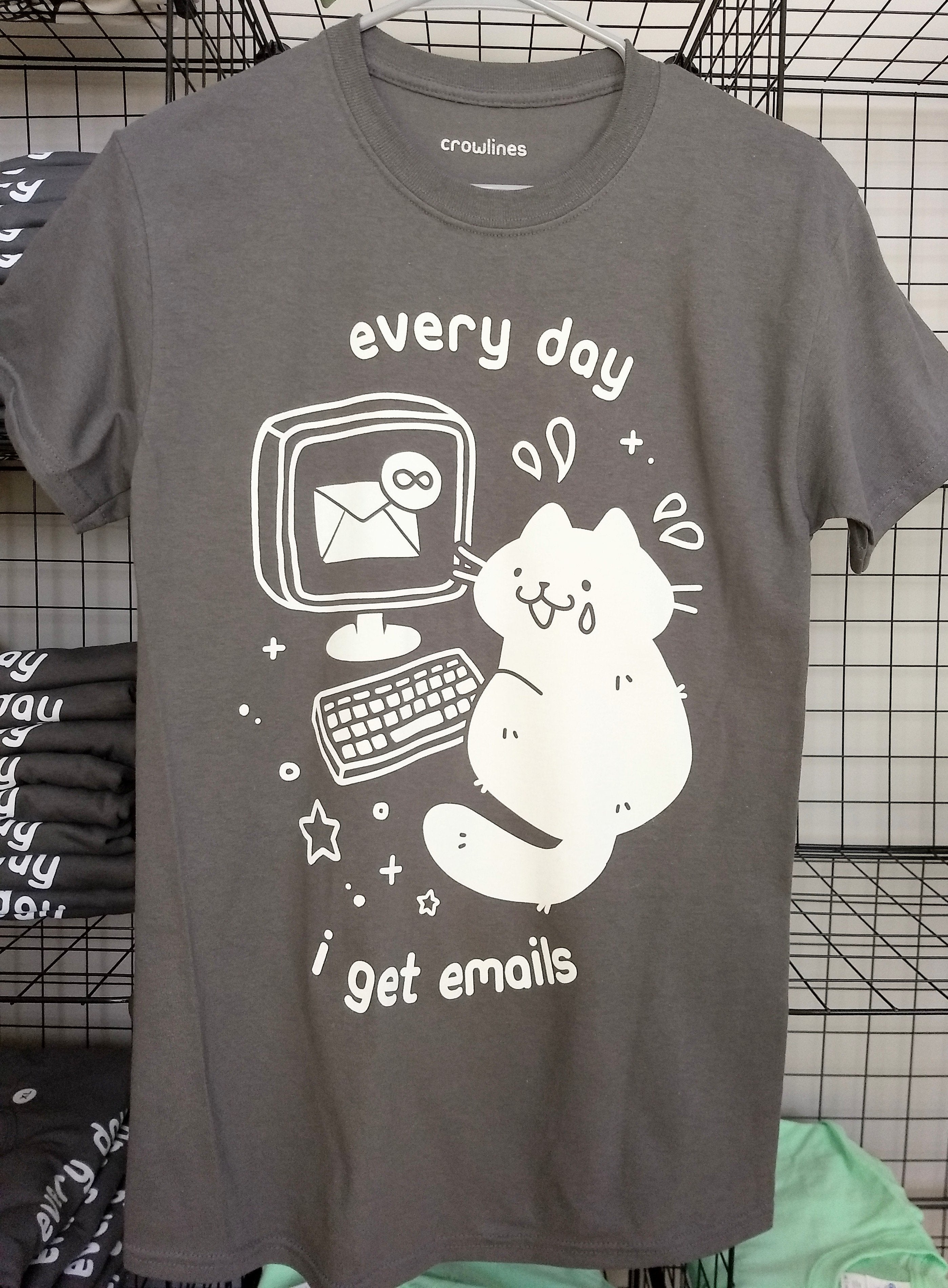 gray short sleeve tee with a white graphic of a cat with a tear on its face in front of a laptop showing inbox infinity and the text