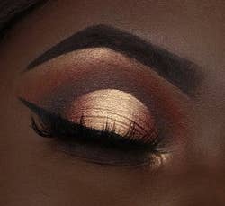 Close-up of a person's eye with dramatic eyeshadow and eyeliner, perfect for makeup shopping inspiration