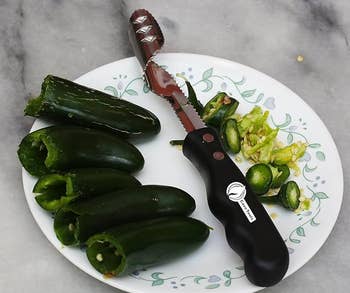 photo of  five jalapeno peppers with cores and seeds removed sitting next to the tool