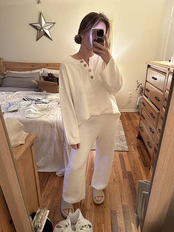 Person wearing cozy, stylish loungewear poses successful  a chamber  mirror, highlighting a casual buying  outfit