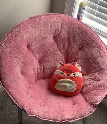 Reviewer image of pink chair with a red fox throw pillow