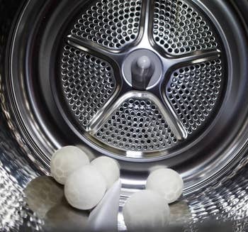 five of the white wool dryer balls in a dryer