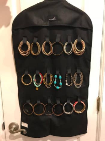 reviewer photo of the opposite side of the organizer with loops for holding necklaces and bracelets without tangling
