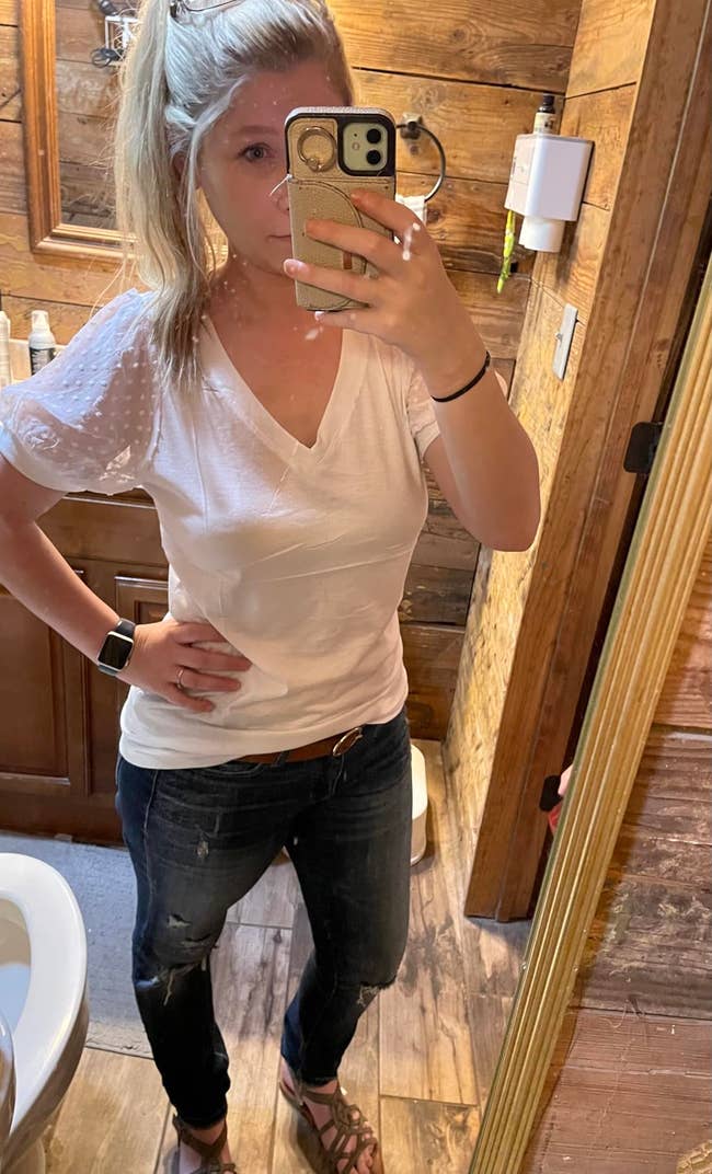  short-sleeve achromatic  top, jeans, and sandals, lasting  successful  a wood-paneled room