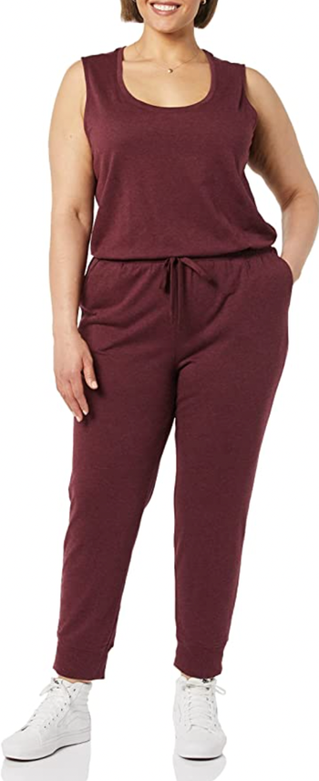 a model wearing the jumpsuit in the color burgundy heather
