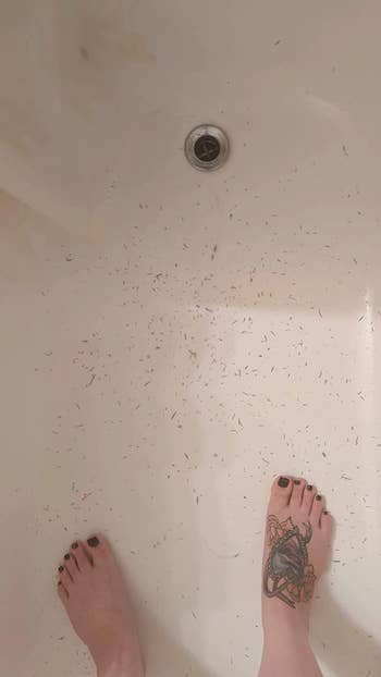 A reviewer's feet in the tub showing all the dead skin they got off their body