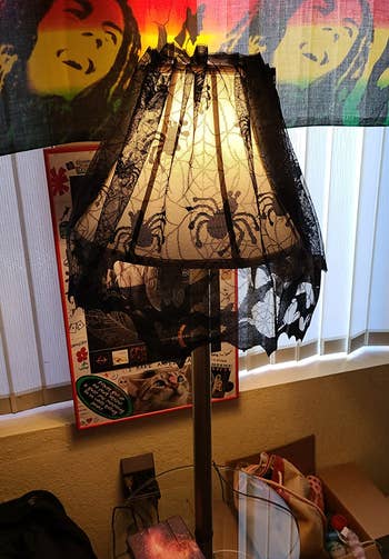 the spider web lampshade cover around a reviewer's  cone-shaped lamp