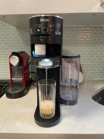 buzzfeed writer using sparkling water maker with fizzy orange mango flavor