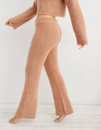 a model wearing a tan fuzzy pair of pants