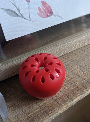 A small red apple shaped trap 