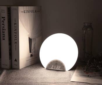 The circular timepiece glowing white