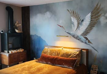 Bedroom with a ample vertebrate mural supra a bed, featuring plush pillows and luxurious bedding. A woody nightstand and decorative fox are successful the corner