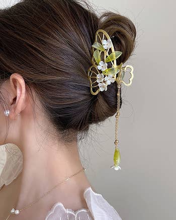 model wearing jasmine-inspired claw clip with an updo