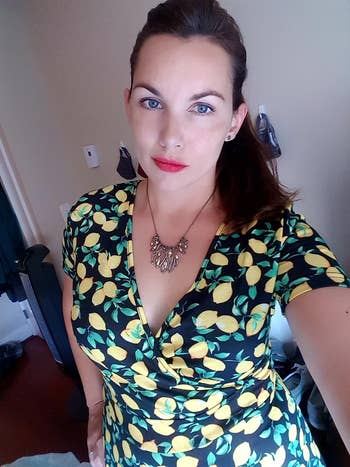 image of reviewer wearing black and yellow floral dress