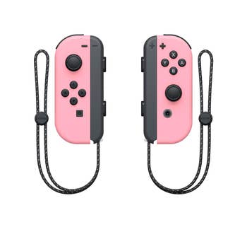 Pair of pink Joy-Con controllers for Nintendo Switch with wrist straps
