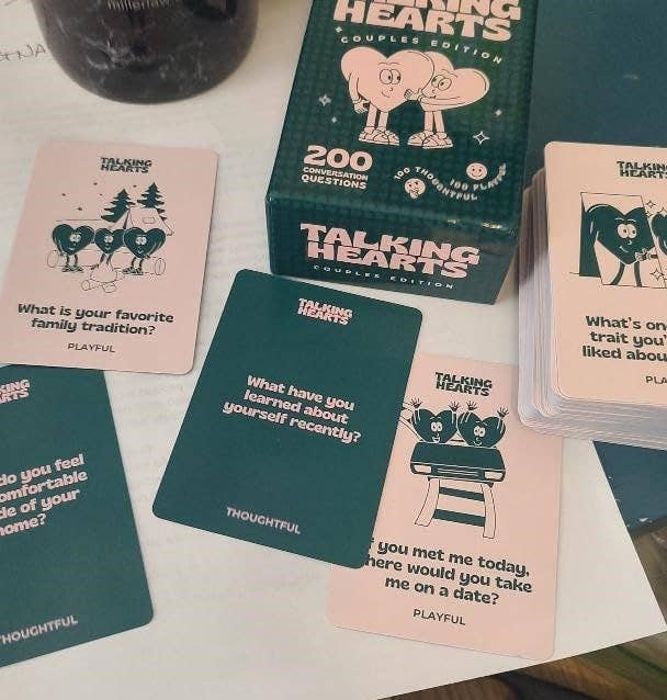 Talking Hearts Couples Edition card game displayed with open cards showing questions and prompts such as