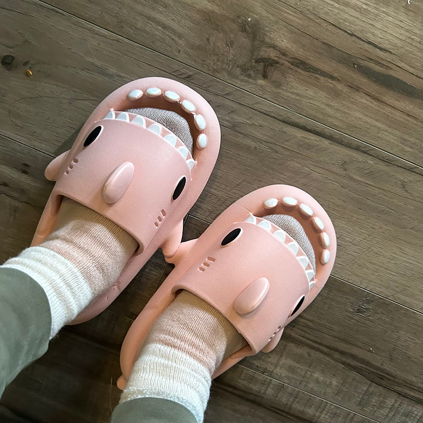 reviewer wearing pink shark slides