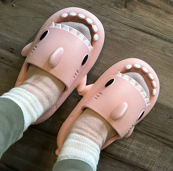 reviewer wearing pink shark slides
