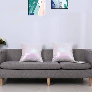 The iridescent pillows on a grey couch