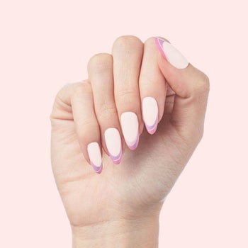 a model with a press-on french manicure in purple and pink