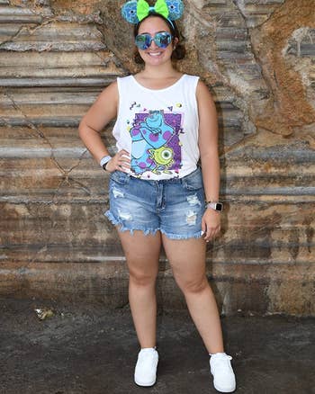 Reviewer in medium wash distressed hem shorts with holes 