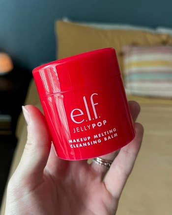 Person holds a jar of e.l.f. Jelly Pop Makeup Melting Cleansing Balm, suitable for constitution  removal