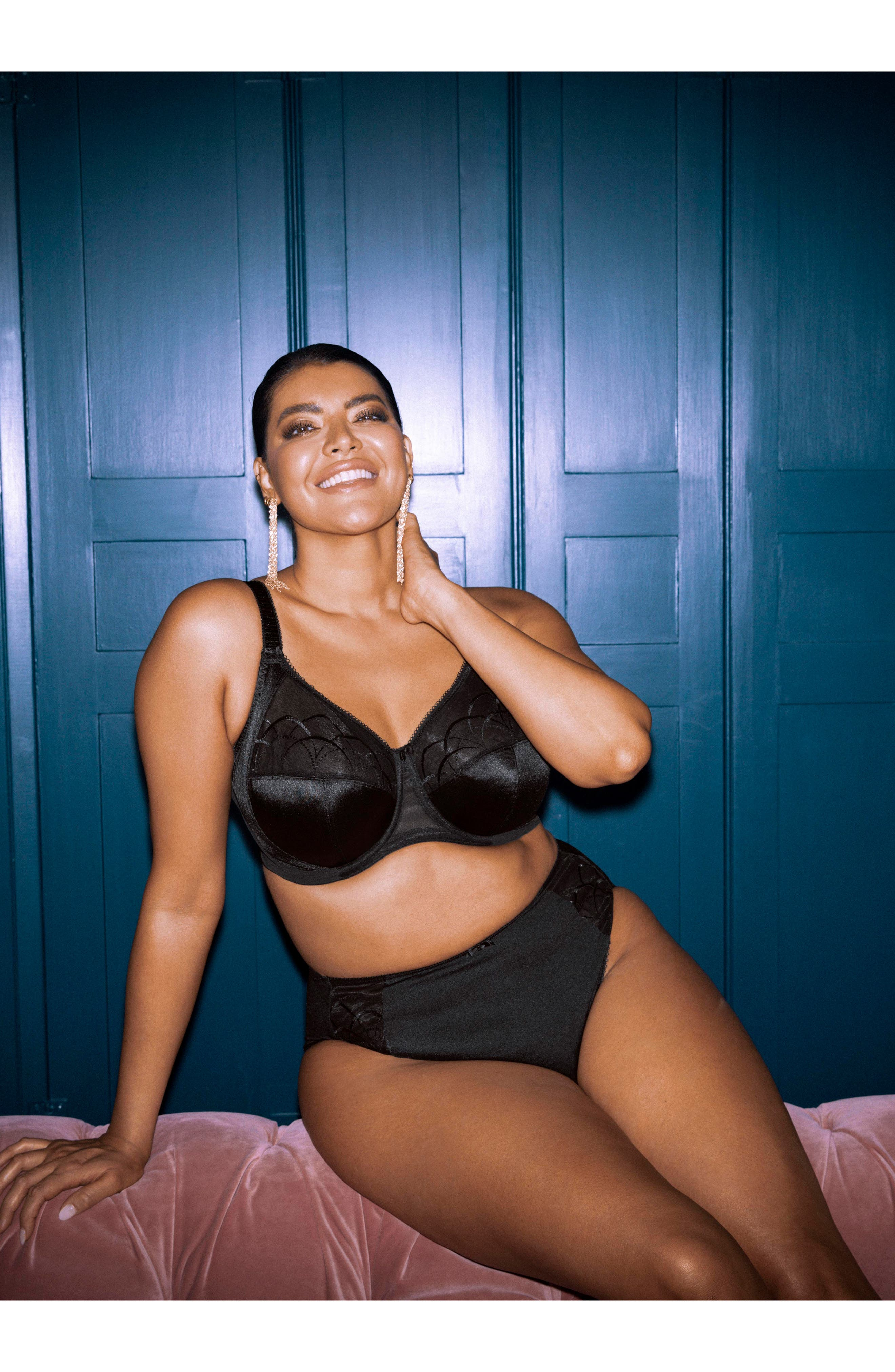 Model successful  stylish achromatic  lingerie acceptable   poses confidently against paneled wall