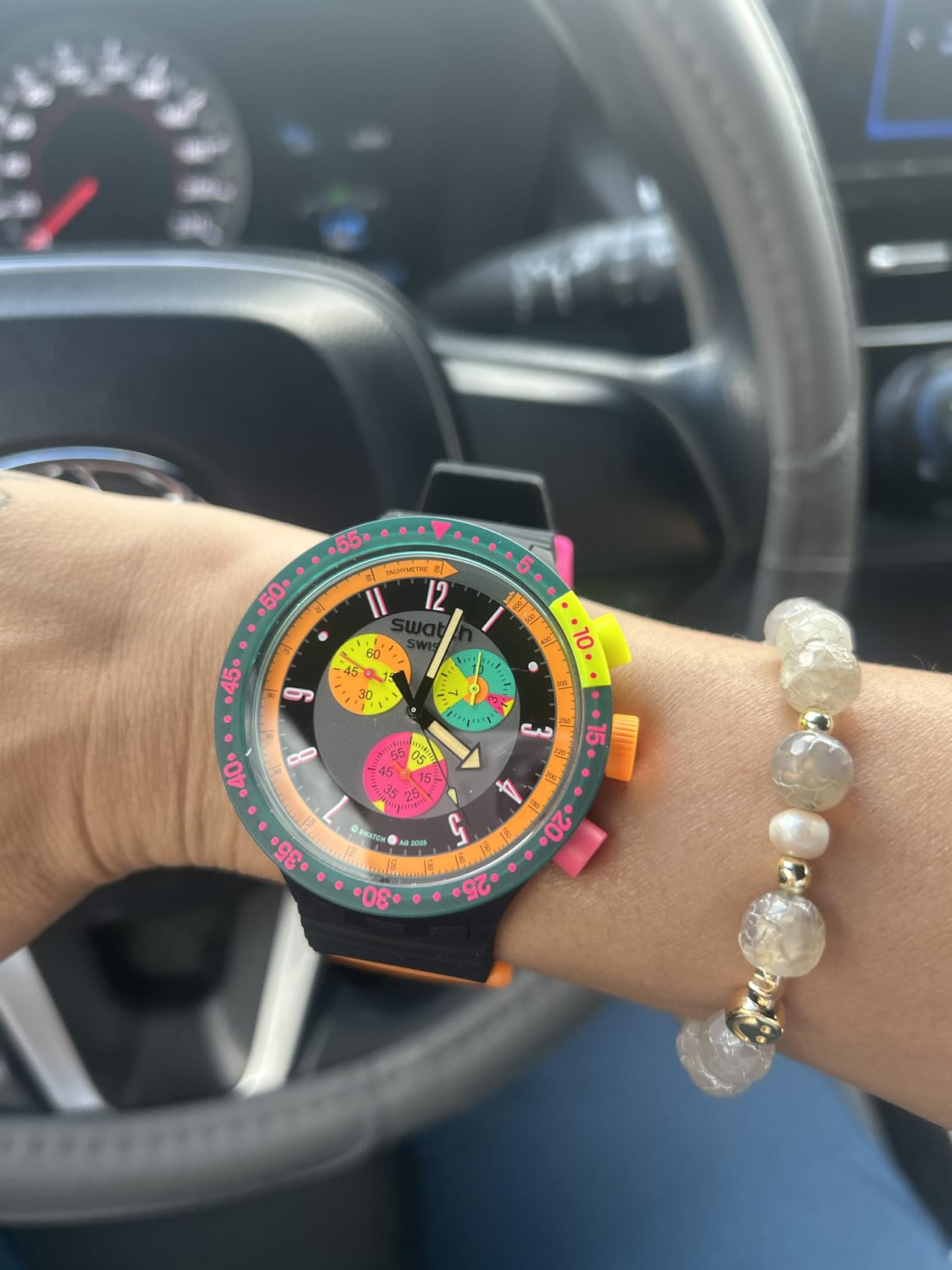 reviewer wearing the ticker  successful  the Neon Seppia colorway with a pearl bracelet