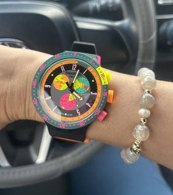 reviewer wearing the ticker successful the Neon Seppia colorway with a pearl bracelet
