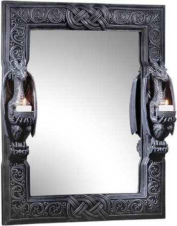 A mirror with two dragon candle holders on each side