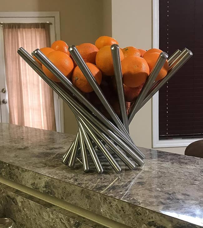 a centerpiece bowl holding oranges on reviewer's counter