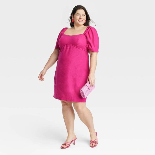 model wearing hot pink puff sleeve dress