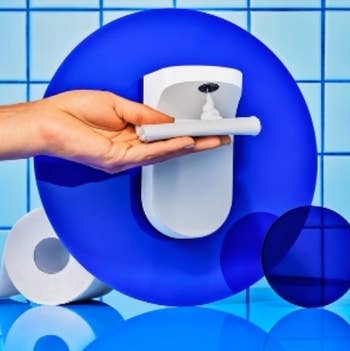 close up of a hand applying fohm to toilet paper