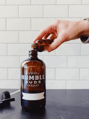 gif of person refilling spray bottle with more cleaning concentrate