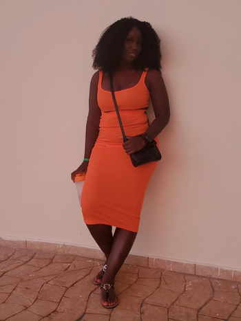 reviewer wearing the orange set