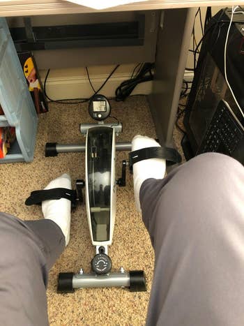 reviewer using the desk cycle under their desk 