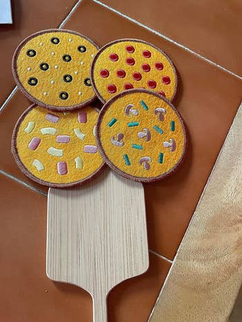 reviewer's mini paddle with the four coasters